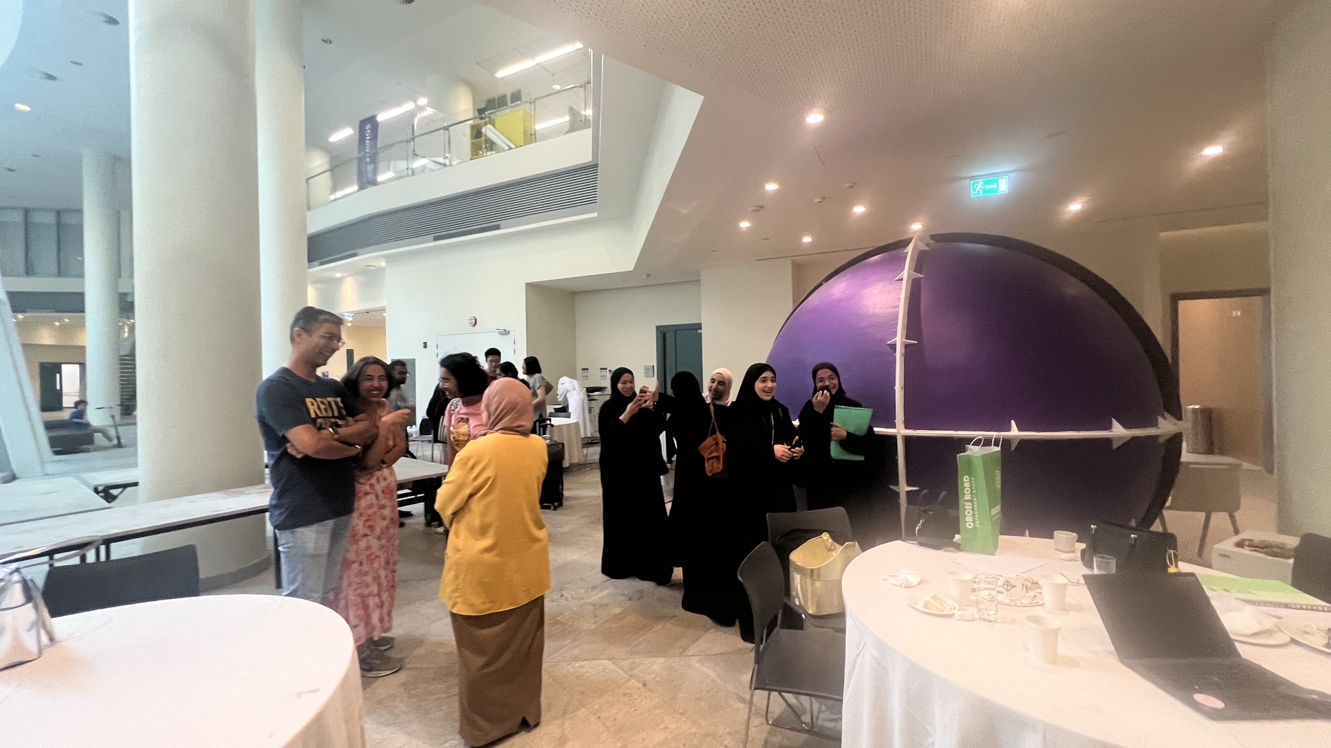 Participants walking across the NYU Abu Dhabi campus during the 2025 training program